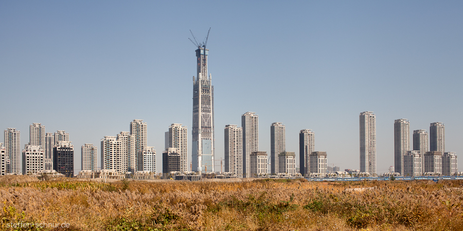Tianjin
 China
 concrete
 construction site
 cranes
 meadow
 skyscraper
