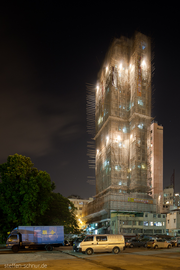 Hong Kong
 China
 bamboo scaffolding
 fusion from exposure bracketing
 apartment house
 veiled
