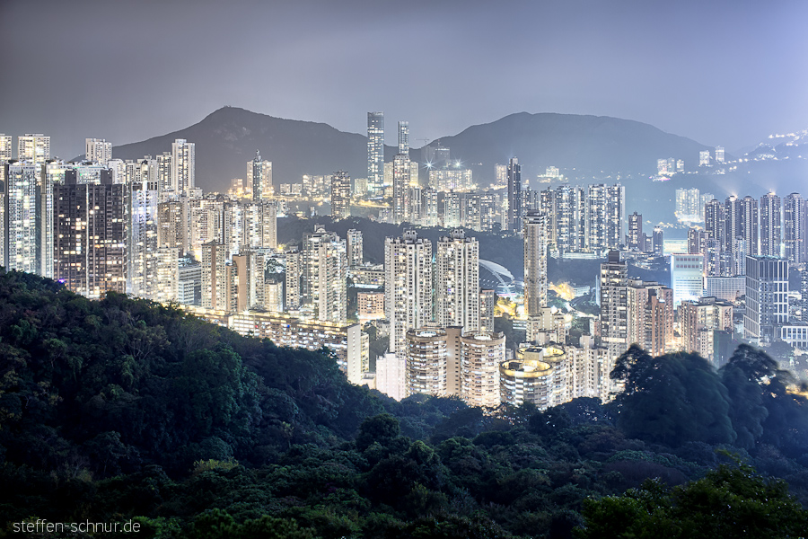 mountains
 Hong Kong
 China
 metropolis
 skyscrapers
 sea of houses
 forest
