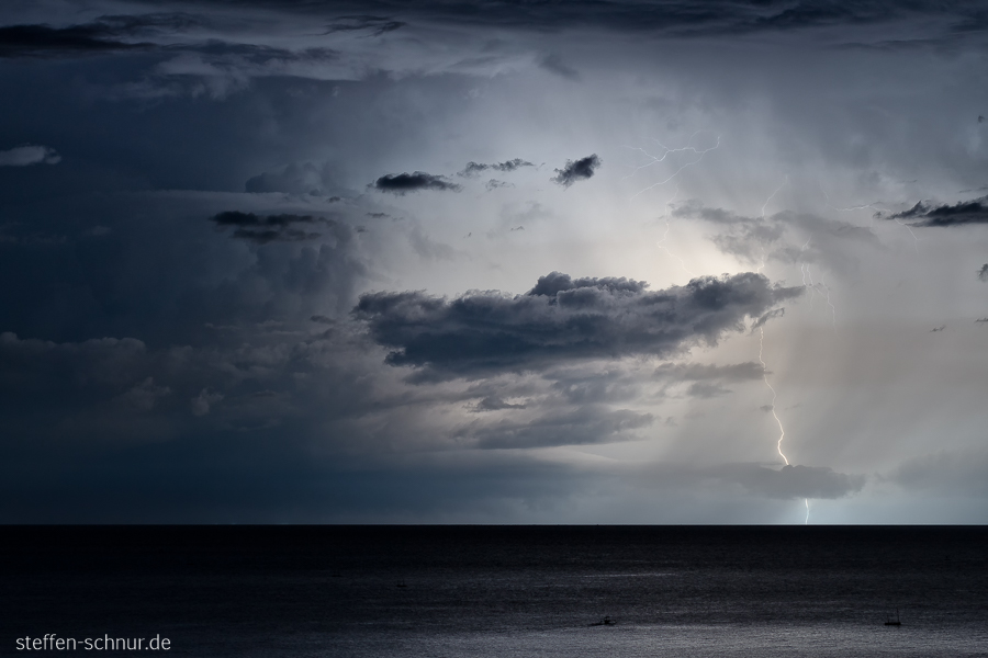 fishing boats
 lightning
 thunder storm
 Bali
 Indonesia
 sea
 night
