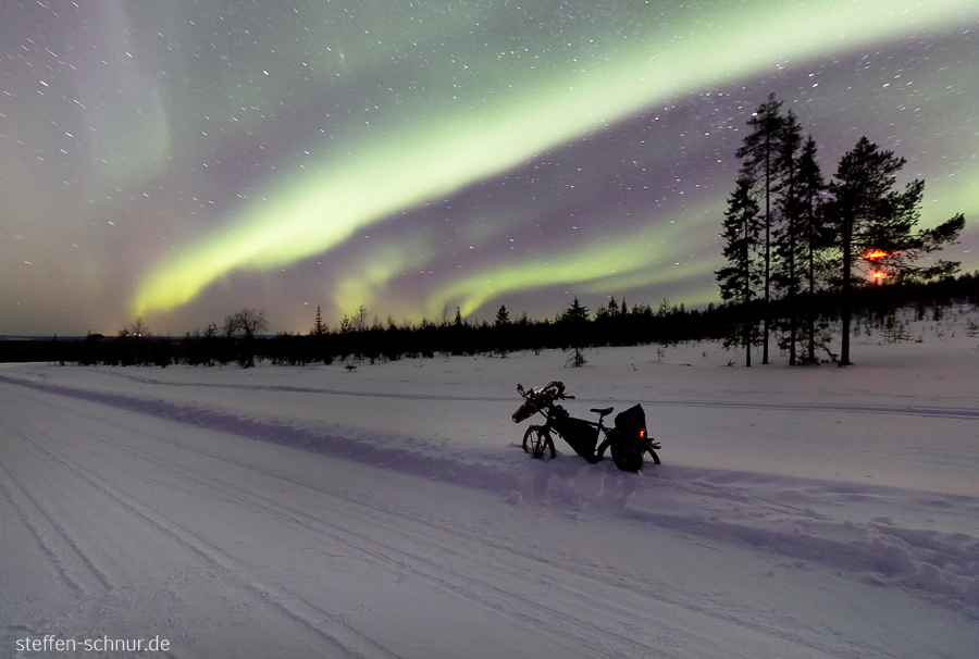 northern lights
 bike
 Lapland
 Finland
