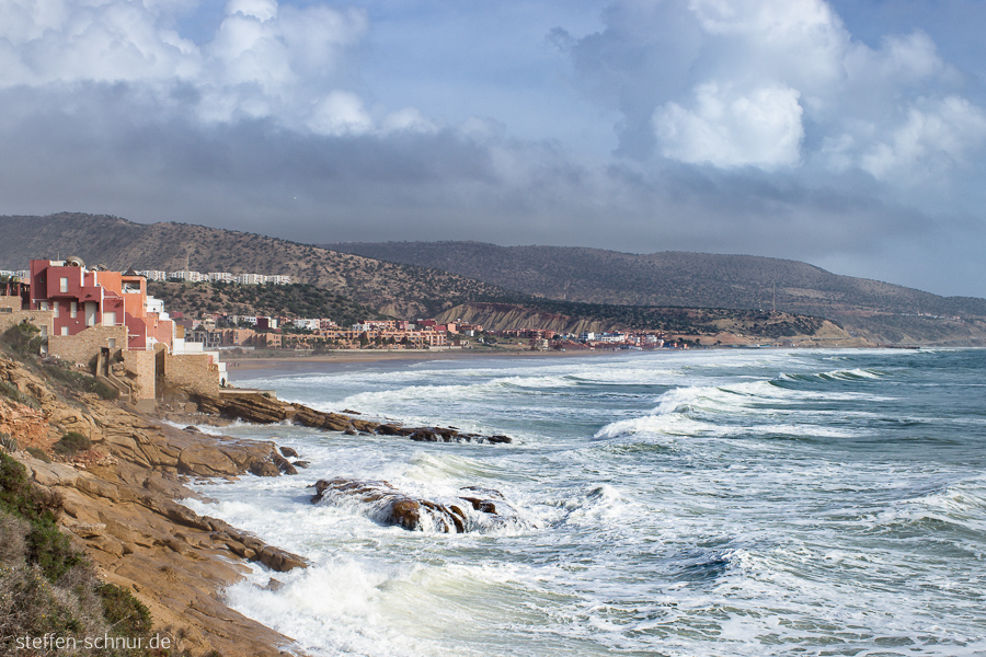 Morocco
 rock
 houses
 coast
 sea
 waves
