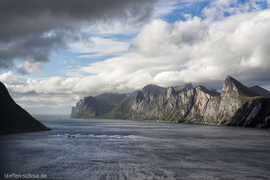 Senja
 mountain chain
 fish farm
 fjord
 Norway
 dark clouds
