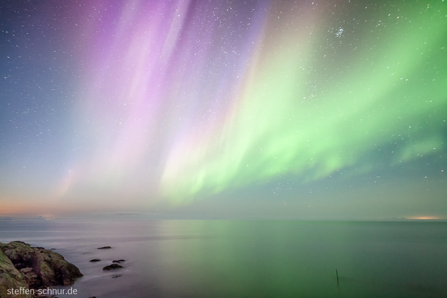 North Sea
 rock
 Lofoten
 night
 Northern lights
 Norway
 stars
