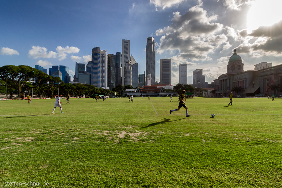 city skyline
 Singapore
 football
 soccer player
 sun
 skyscraper
