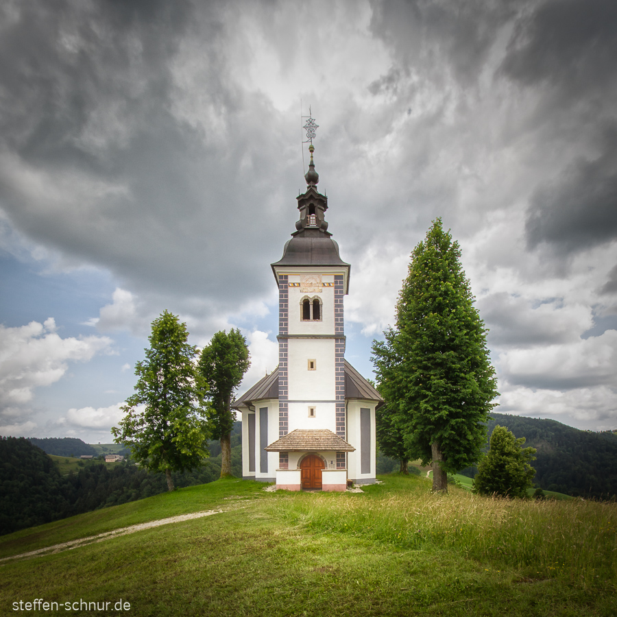 church
 Slovenia
 tree
 dark clouds
