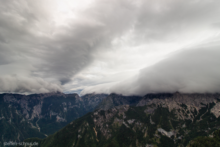 mountains
 Slovenia
 mountain top
 blanket of clouds
