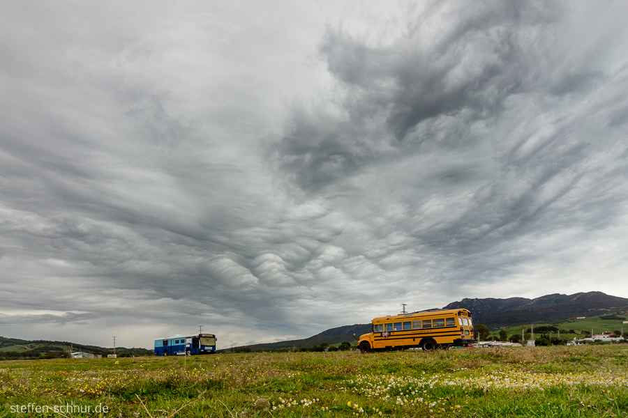 coach
 Spain
 Andalusia
 School bus
 meadow
 clouds

