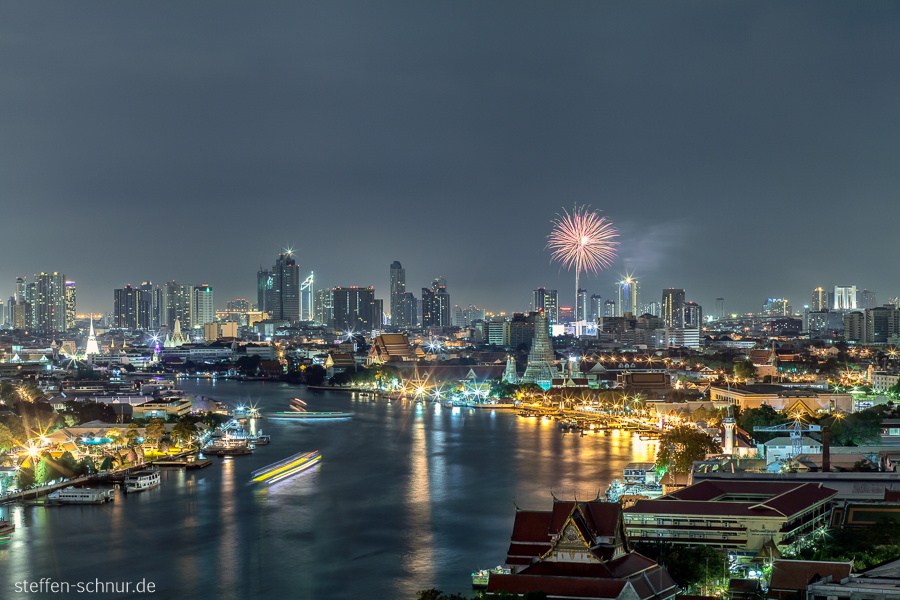 city skyline
 Chao Phraya River
 fireworks
 Bangkok
 Thailand
 night
 ships
