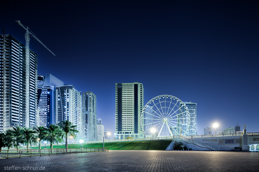 big wheel
 Sharjah
 architecture
 building lot
 Trees
 crane
 UAE
