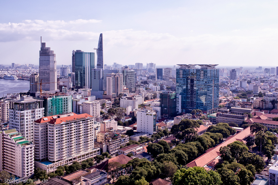 Bitexco Financial Tower
 city skyline
 Ho Chi Minh City
 Saigon
 Vietnam
 Trees
 river
